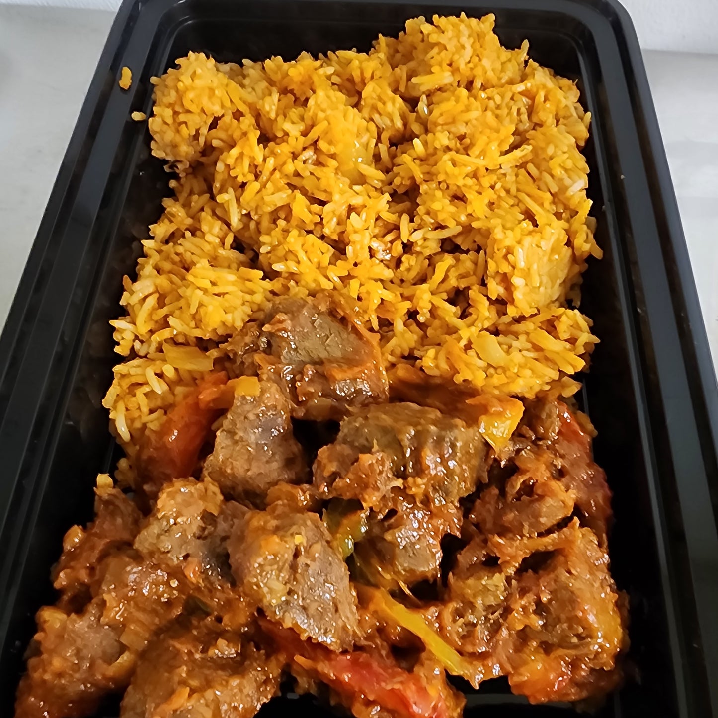Jollof Rice and spicy goat meat/Beef